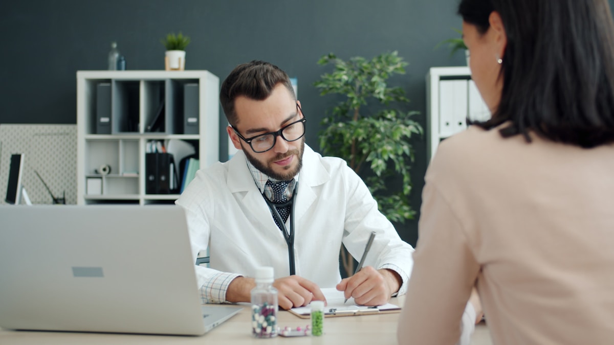 Clinician reviewing patient notes in a medical office